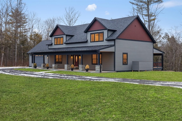 view of front facade with a front yard and covered porch