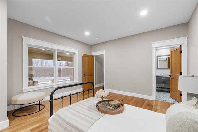 interior space with ensuite bath and light hardwood / wood-style floors