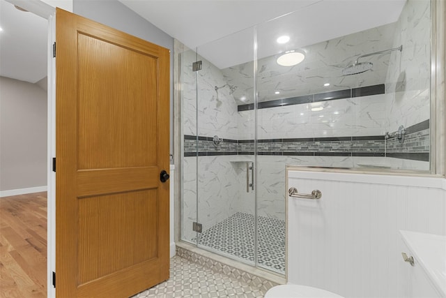 bathroom with hardwood / wood-style floors and walk in shower