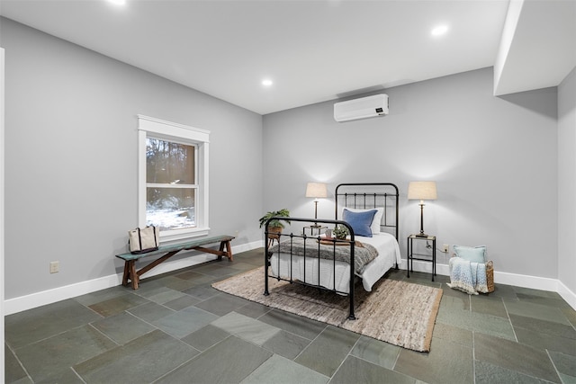 bedroom with an AC wall unit