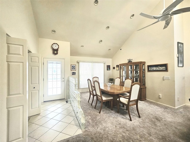 dining space featuring ceiling fan, light tile patterned floors, and high vaulted ceiling