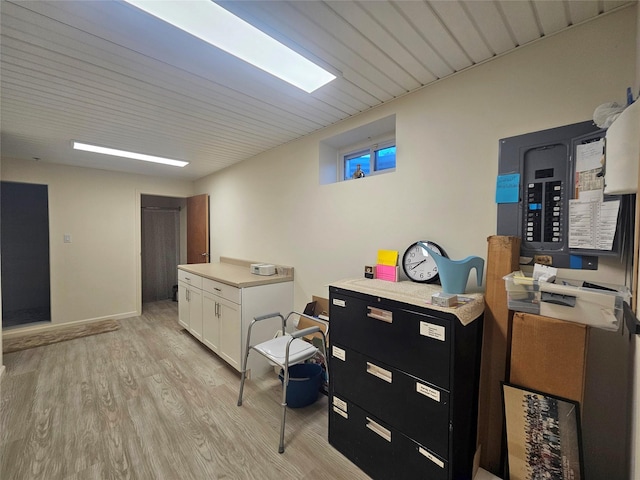 interior space featuring electric panel and light wood-type flooring