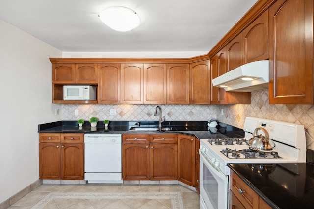 kitchen with light tile patterned floors, sink, decorative backsplash, and white appliances