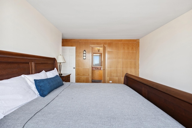 bedroom featuring wood walls