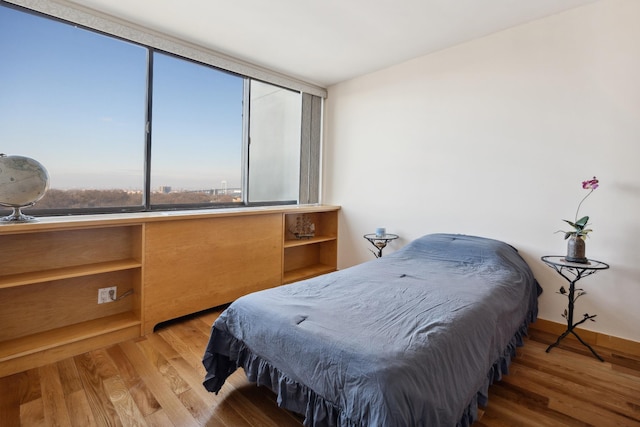 bedroom with wood-type flooring