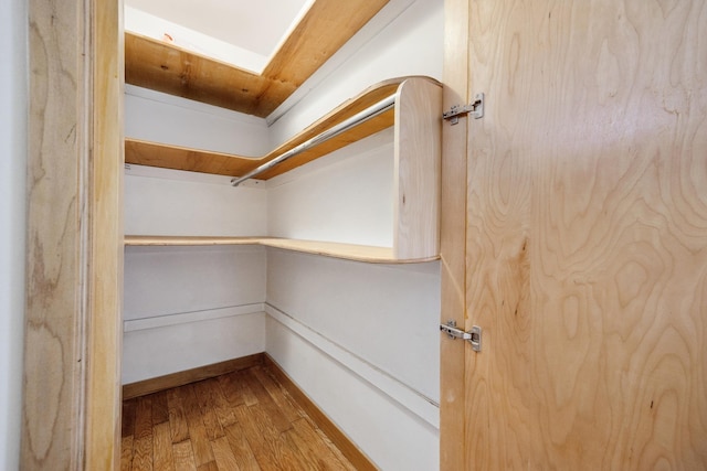 walk in closet featuring light hardwood / wood-style flooring