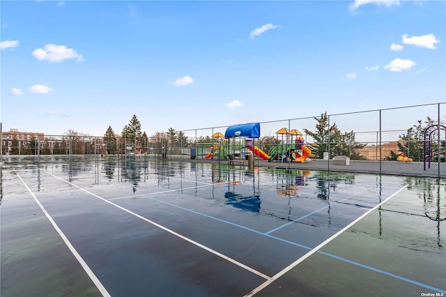 view of sport court featuring a playground