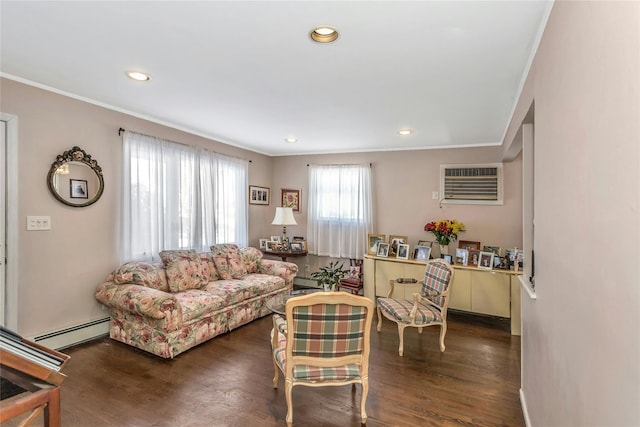 living room with a baseboard heating unit, dark wood-type flooring, ornamental molding, and a wall unit AC