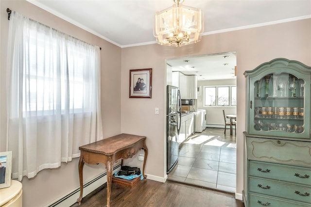 dining space with dark hardwood / wood-style floors, ornamental molding, a chandelier, and a baseboard radiator