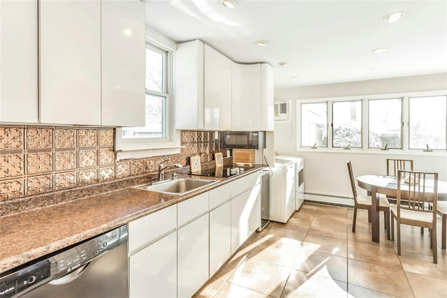 kitchen with white cabinetry, decorative backsplash, dishwasher, washing machine and dryer, and sink