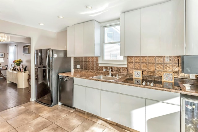 kitchen featuring wine cooler, stone counters, black appliances, sink, and white cabinetry