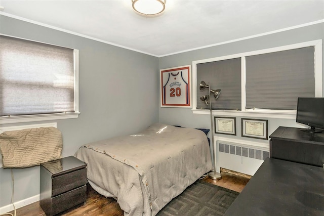 bedroom with radiator, crown molding, and dark hardwood / wood-style floors