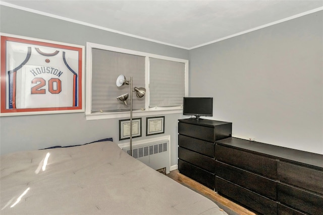 bedroom with radiator and crown molding