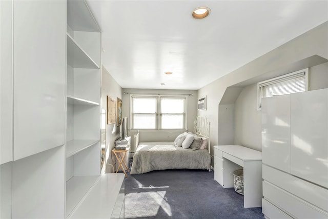 bedroom featuring a wall unit AC and dark colored carpet