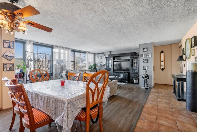 tiled dining room with a textured ceiling