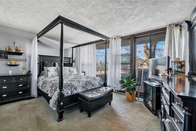 bedroom with expansive windows, a textured ceiling, and carpet flooring