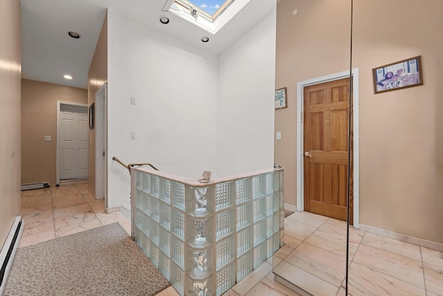 138-65 63rd Ave, Flushing, NY 11367 - hallway featuring marble look tile flooring, a baseboard radiator, baseboards, a skylight, and a towering ceiling