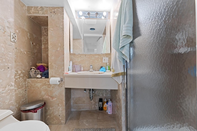 138-65 63rd Ave, Flushing, NY 11367 - bathroom with tile walls, toilet, a stall shower, and a sink