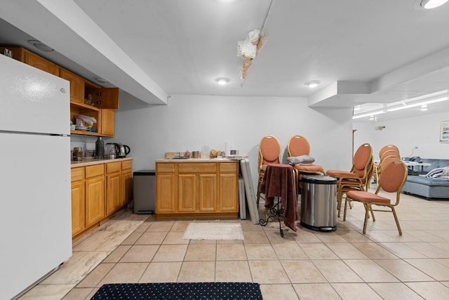 138-65 63rd Ave, Flushing, NY 11367 - kitchen featuring freestanding refrigerator, light tile patterned flooring, and light countertops