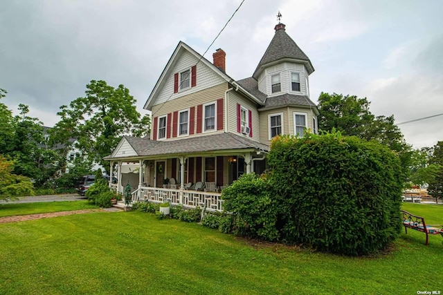 victorian home featuring a porch and a front yard