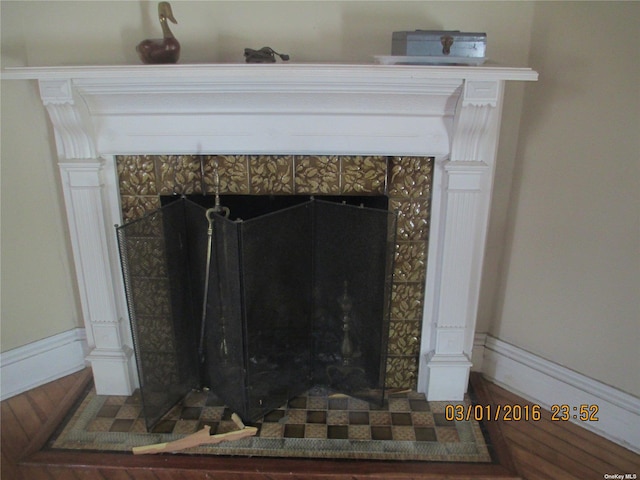 details with a tiled fireplace