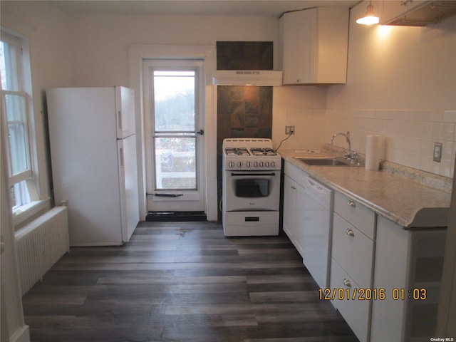 kitchen featuring white cabinetry, radiator heating unit, white appliances, dark hardwood / wood-style flooring, and sink