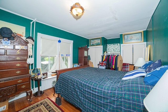 bedroom featuring a closet, crown molding, and hardwood / wood-style flooring