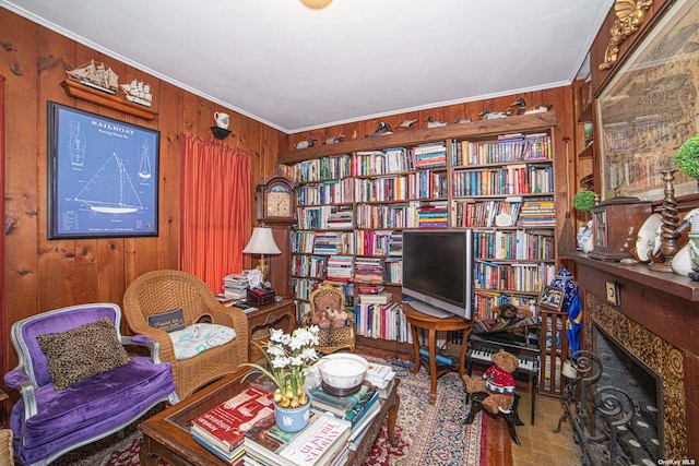 sitting room with a premium fireplace, ornamental molding, and wood walls