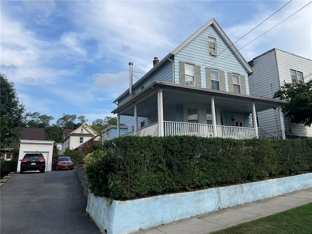 view of front of property with covered porch and a garage