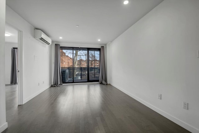 43-12 214th Pl Unit 2A, Bayside, NY 11361 - spare room featuring a wall mounted air conditioner, recessed lighting, dark wood-style flooring, and baseboards