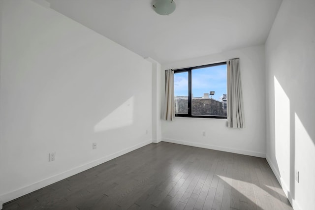 43-12 214th Pl Unit 2A, Bayside, NY 11361 - spare room featuring baseboards and dark wood finished floors