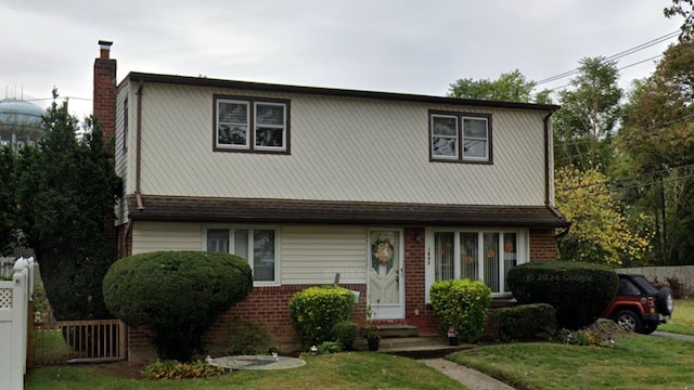 front facade with a front yard