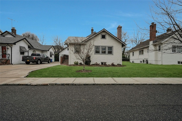 bungalow-style home with a front lawn