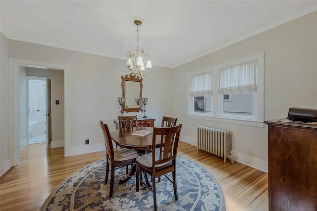 dining space featuring radiator, a chandelier, and light hardwood / wood-style flooring