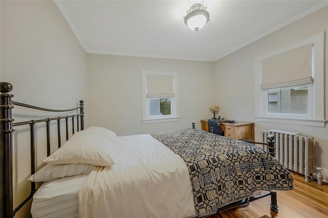 bedroom featuring wood-type flooring and radiator heating unit