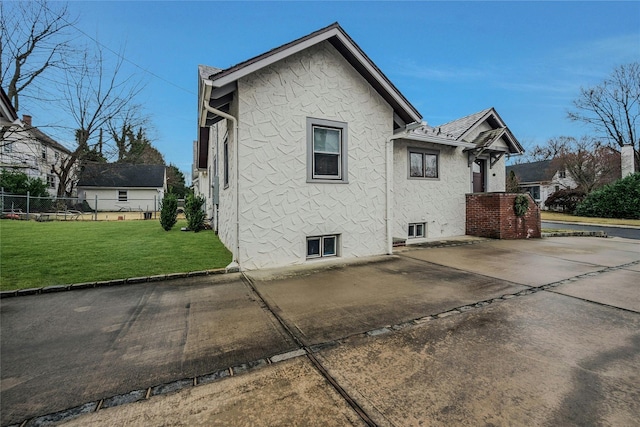 view of home's exterior featuring a lawn and a patio area