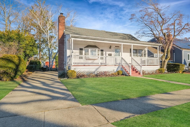 view of front of property with covered porch and a front lawn