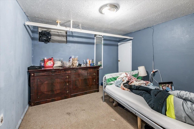 bedroom featuring carpet floors and a textured ceiling