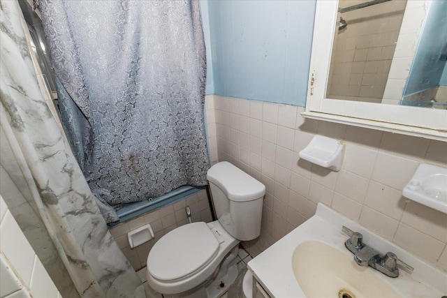 bathroom featuring toilet, tile walls, walk in shower, and vanity