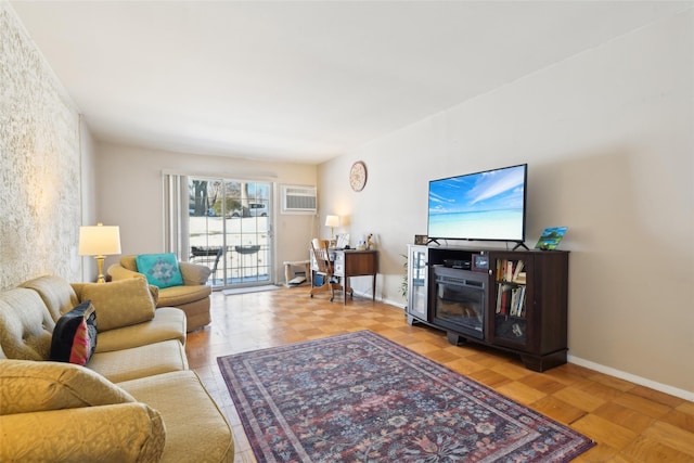 living room featuring a wall mounted AC and light parquet floors