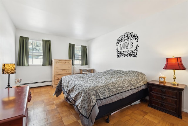 bedroom featuring light parquet floors and a baseboard heating unit