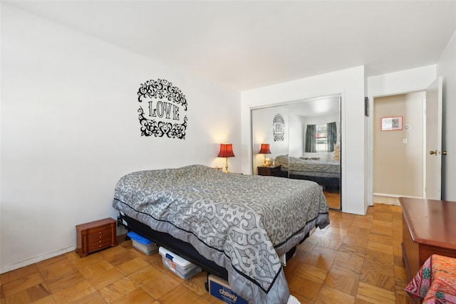 bedroom featuring parquet floors and a closet