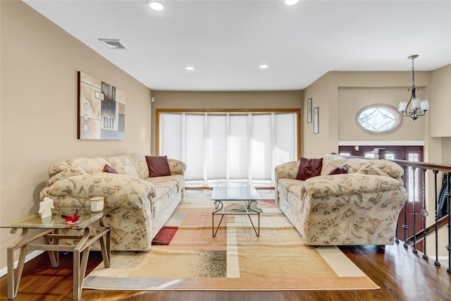 living room featuring hardwood / wood-style flooring and a chandelier