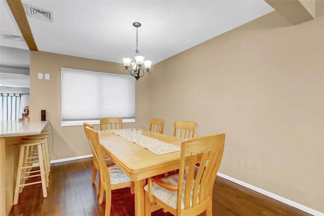 dining room featuring dark hardwood / wood-style flooring and an inviting chandelier