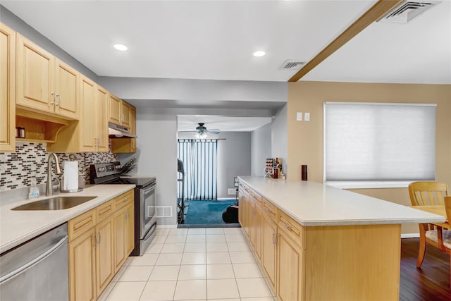 kitchen featuring kitchen peninsula, appliances with stainless steel finishes, tasteful backsplash, light brown cabinetry, and sink