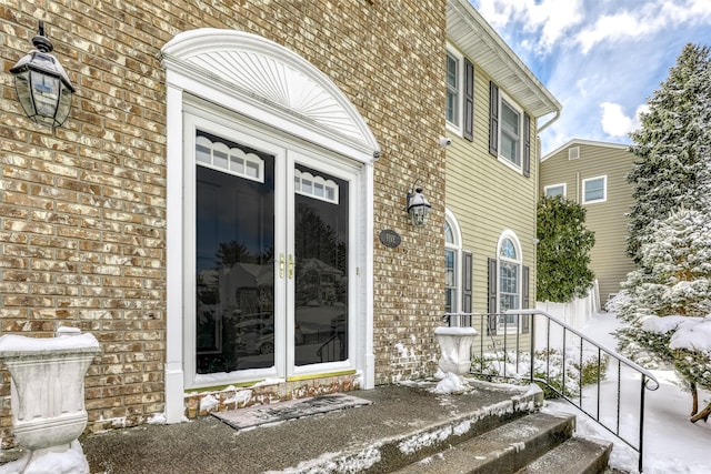 view of snow covered property entrance