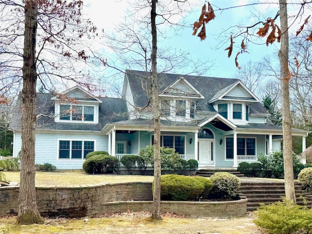 view of front of property featuring a porch and a shingled roof