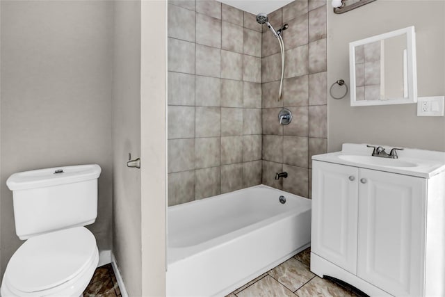 full bathroom with toilet, vanity, and tiled shower / bath