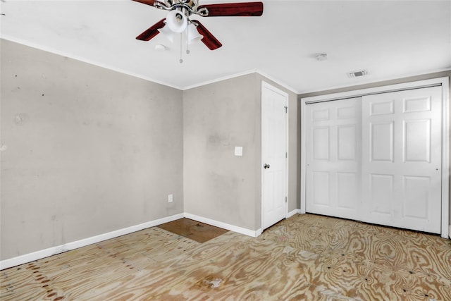 unfurnished bedroom with ceiling fan, a closet, and ornamental molding