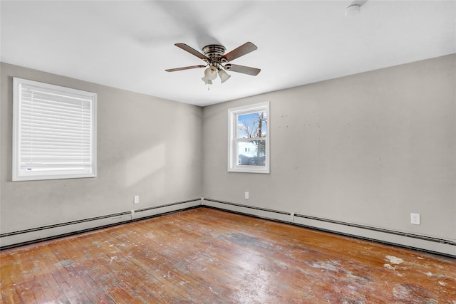 empty room with ceiling fan, baseboard heating, and wood-type flooring